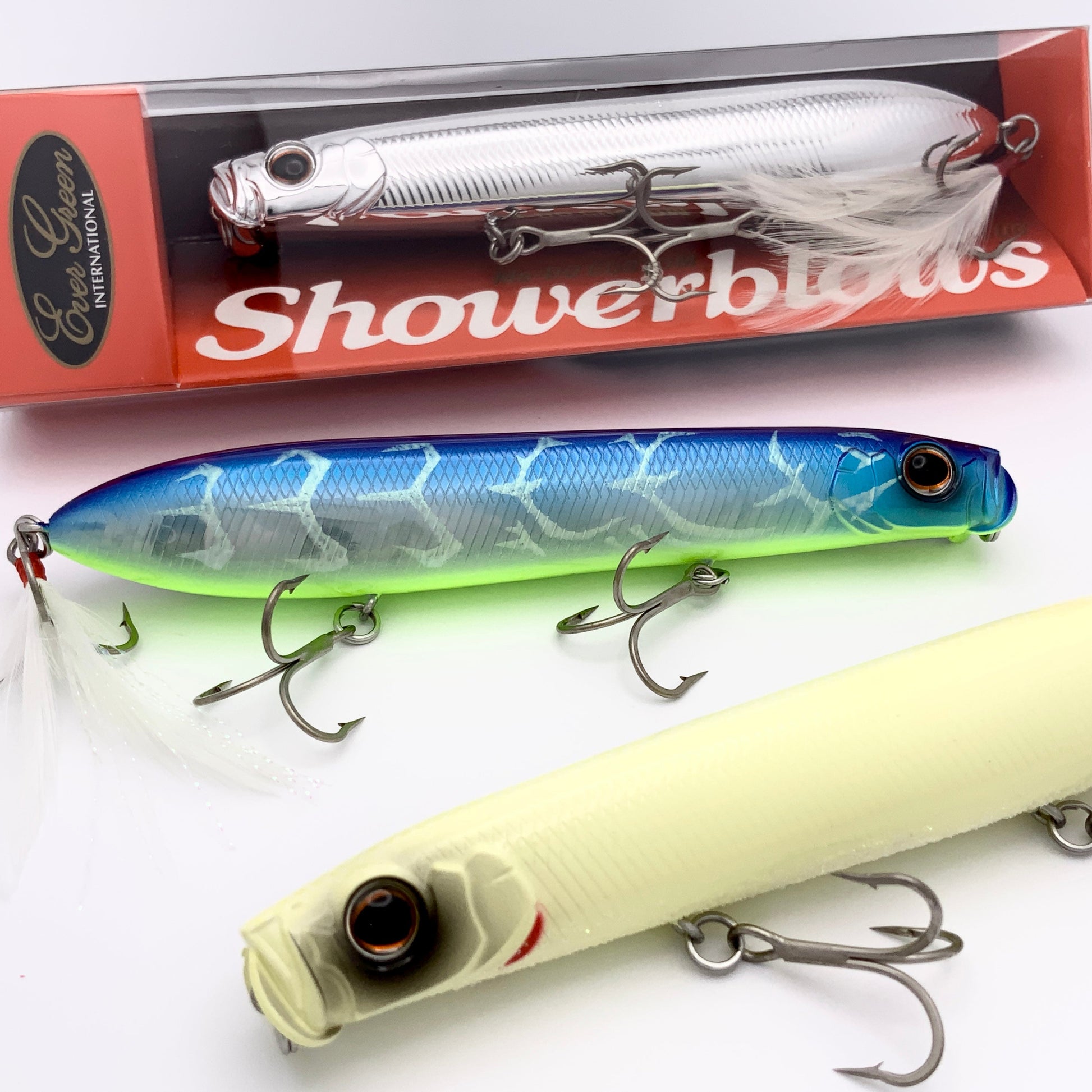 Three fishing lures with a 'Showerblows' box in the background