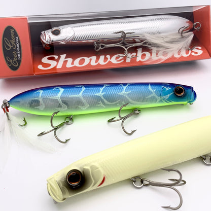 Three fishing lures with a 'Showerblows' box in the background
