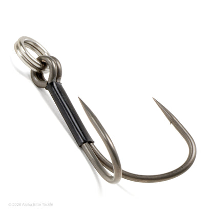 A twin fishing hook with a black wrapped shank and a silver split ring, photographed on a clean white background.