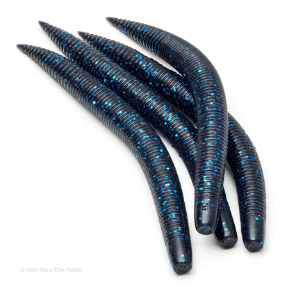 Close-up of multiple blackish-blue soft plastic ribbed stick baits with blue flake on a white background.
