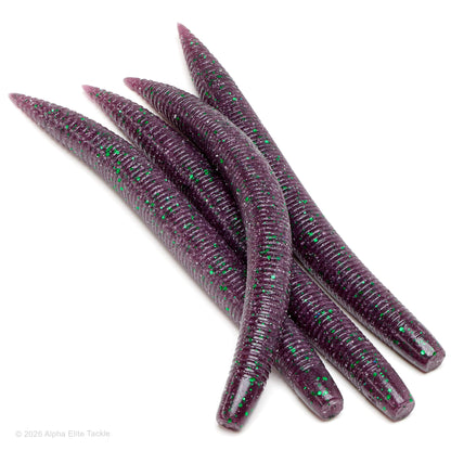 Four ribbed soft plastic worms in a translucent purple color with bright green glitter, arranged on a clean white background.