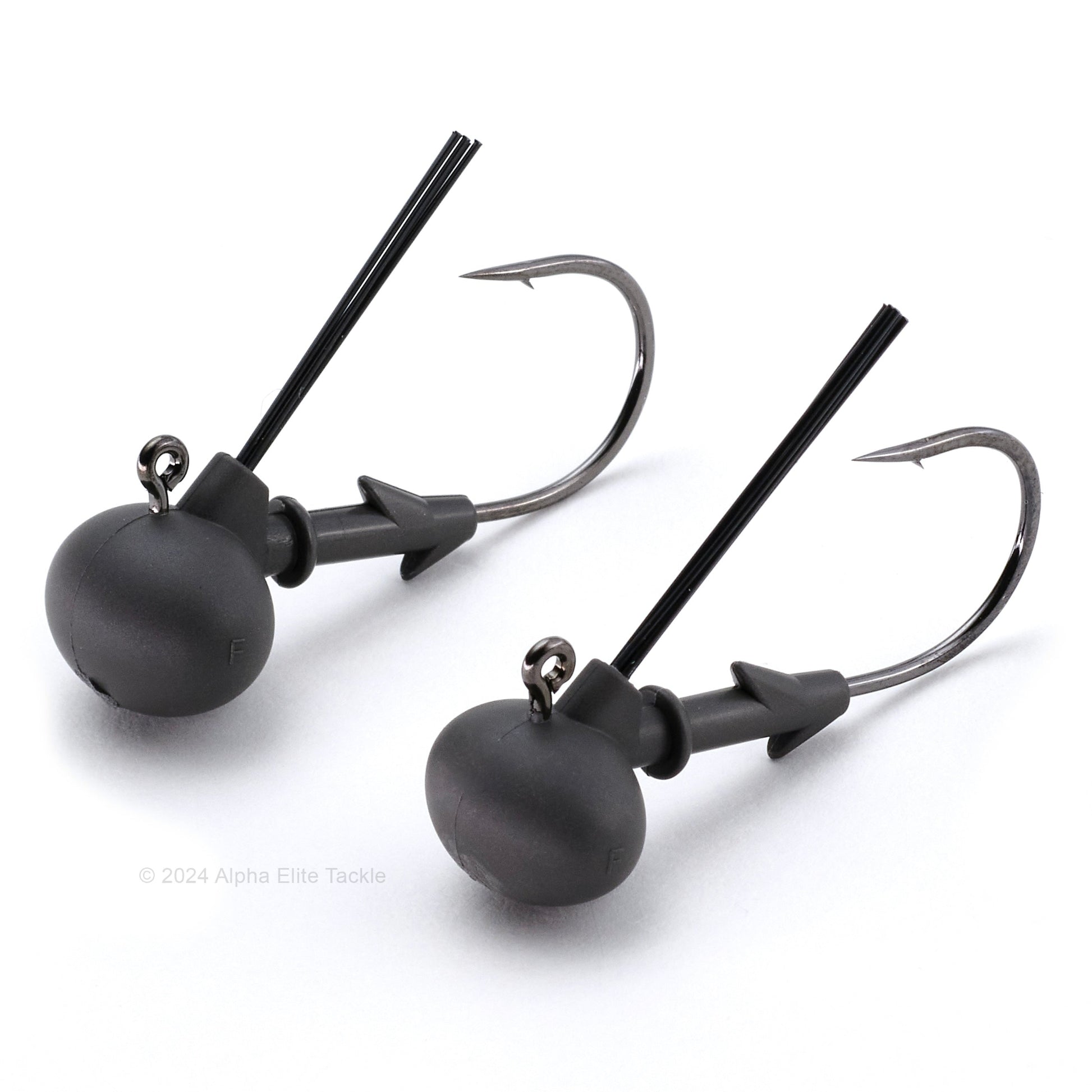 Two matte black keitech tungsten super football jig heads on a white background
