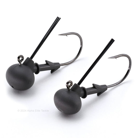 Two matte black keitech tungsten super football jig heads on a white background