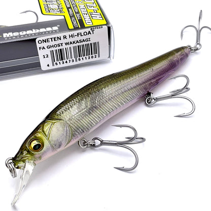 Fishing lure with treble hooks next to its packaging on a white background