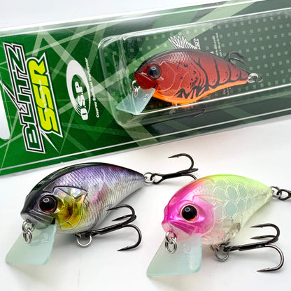 Three colorful fishing lures in front of their packaging on a white background