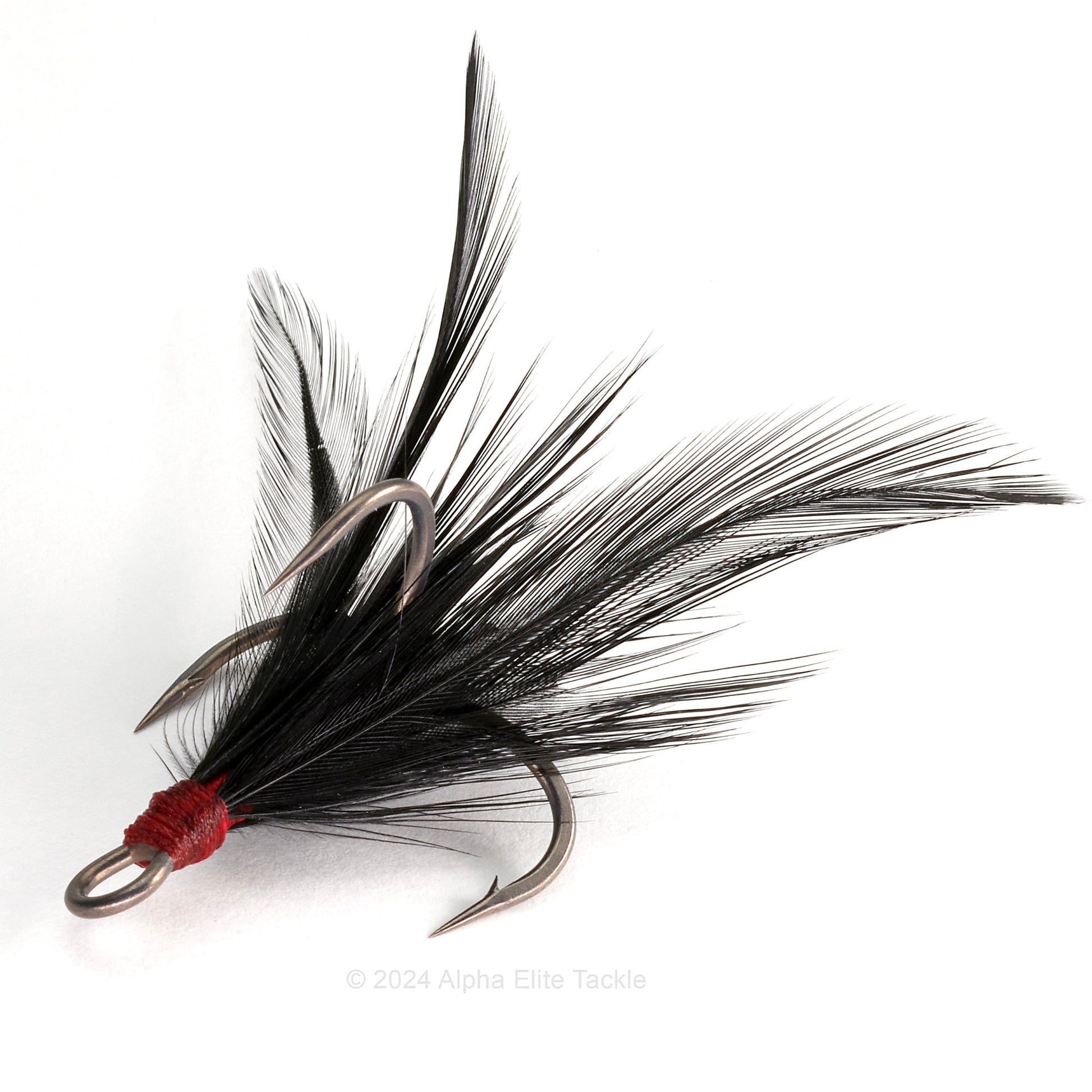 Close up of Ryugi Feathered Pierce TC Treble hook with black feathers on a white background