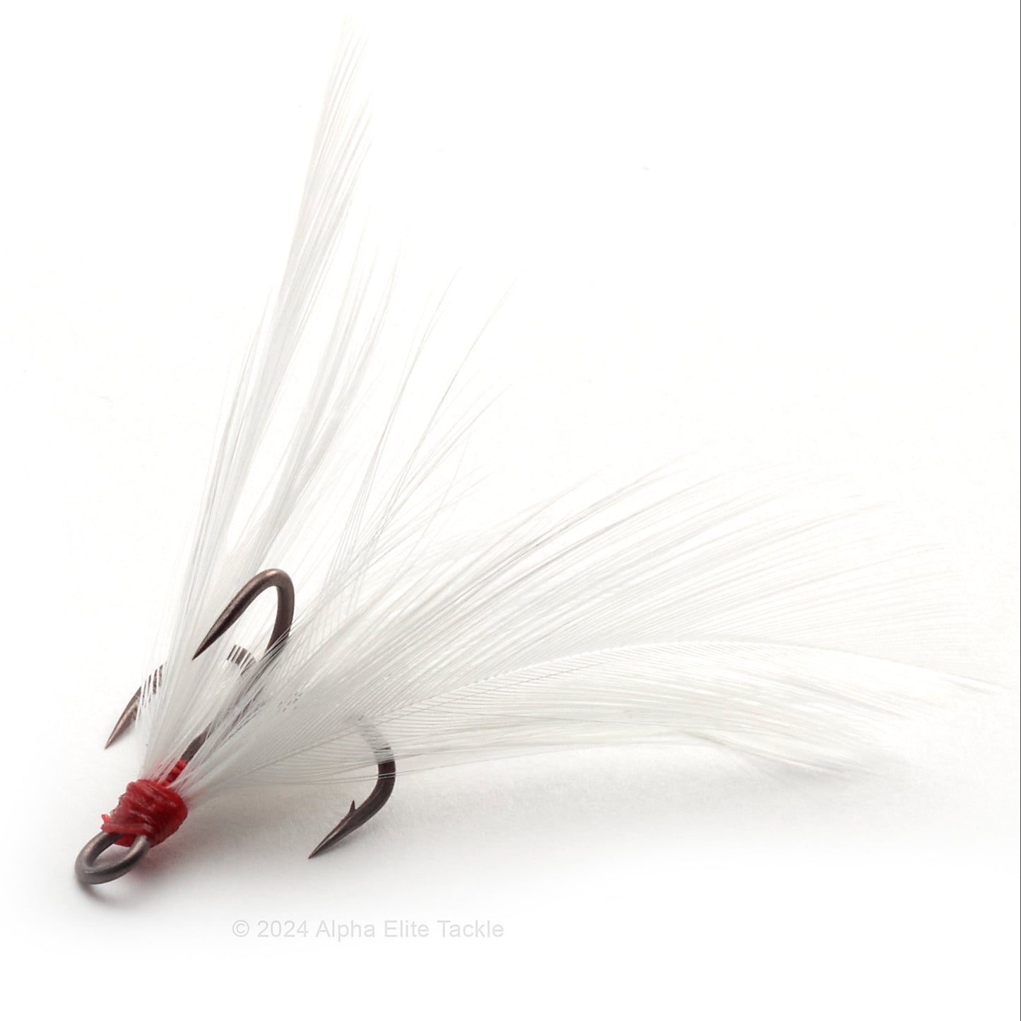 Close up of Ryugi Feathered Pierce TC Treble hook with white feathers on a white background