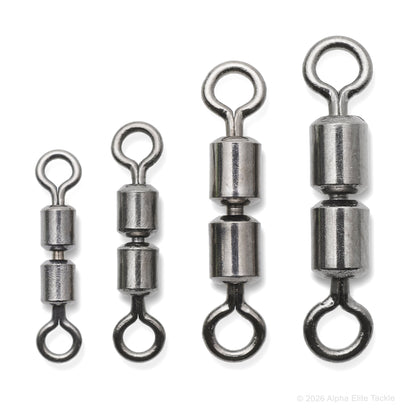 Four metal fishing swivels on a white background