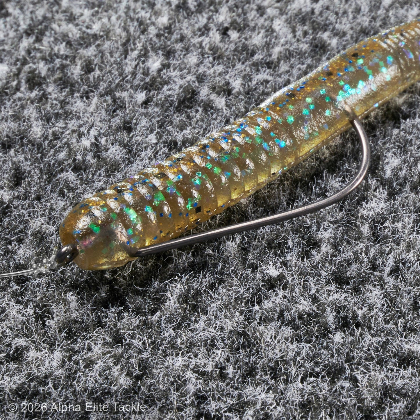 Fishing lure with a hook on a textured gray background