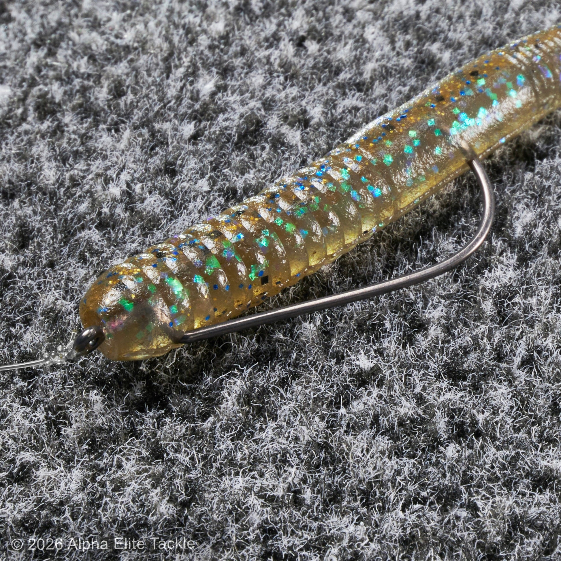 Fishing lure with a hook on a textured gray background