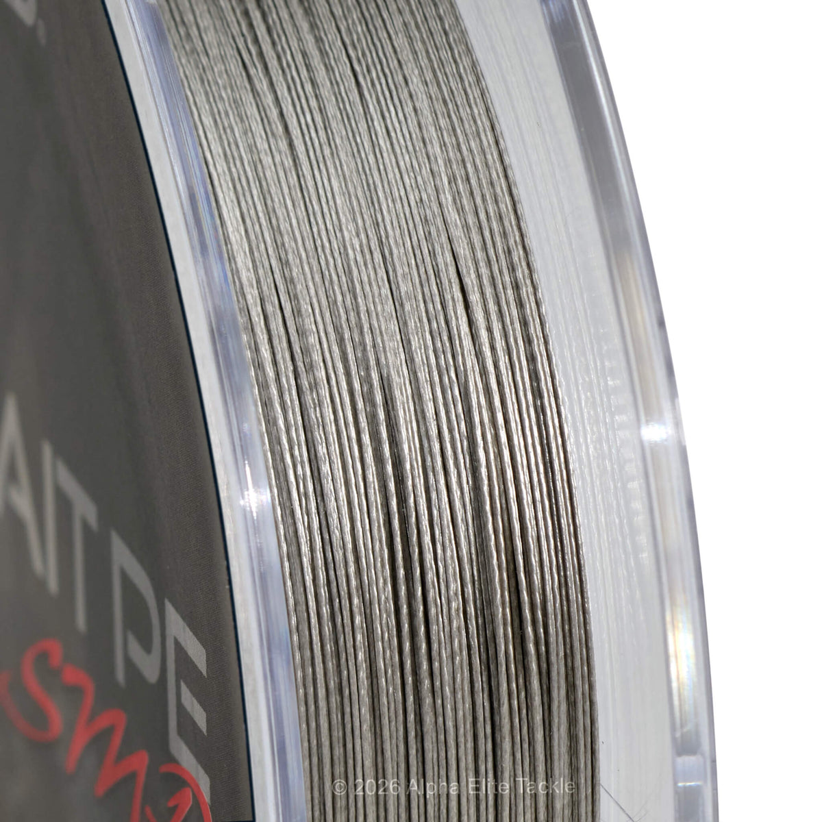 Close-up of a spool of gray braid  fishing line, showing the texture of the line and part of the spool label.