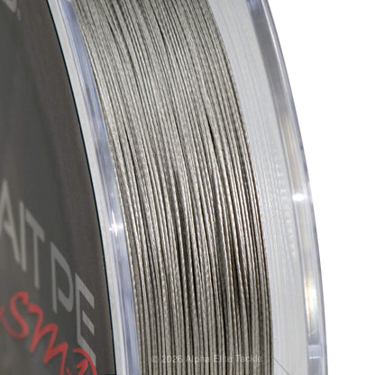 Close-up of a spool of gray braid  fishing line, showing the texture of the line and part of the spool label.